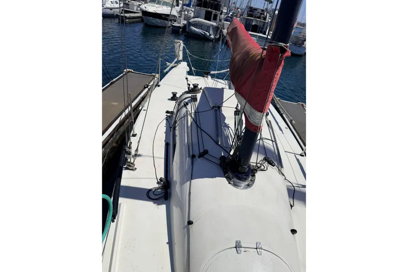Sailboat docked at marina, Flying Tiger 10M, 2007 model, with red sail cover.