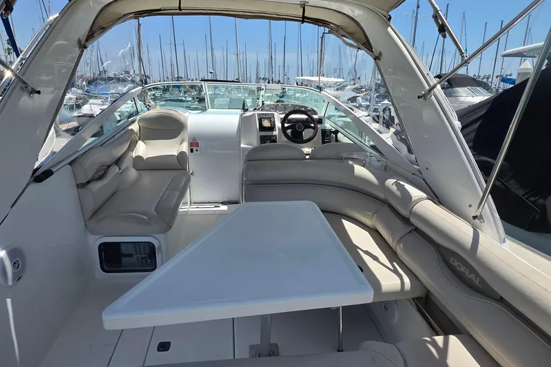 Interior of a 2001 Doral 250se boat with seating and steering wheel.