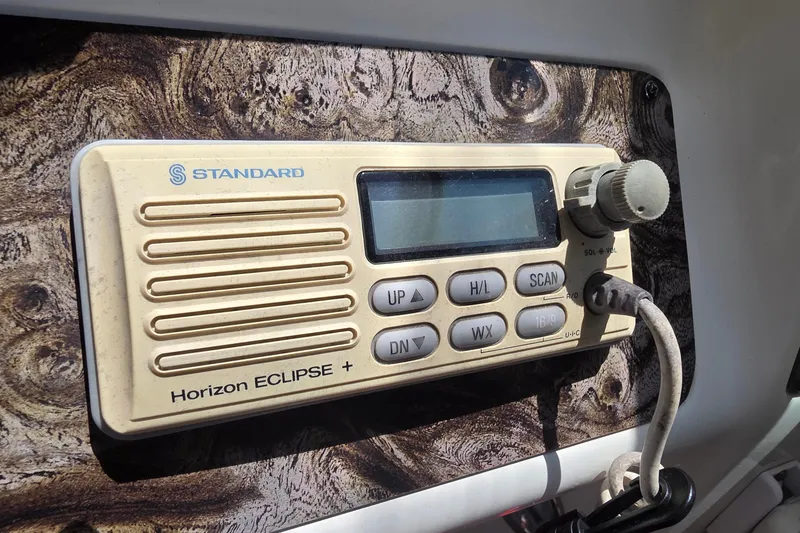 Standard Horizon Eclipse+ radio on a 2001 Doral 250se boat dashboard.