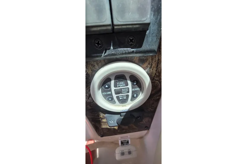 Control panel of a 2001 Doral 250se boat with volume and function buttons.