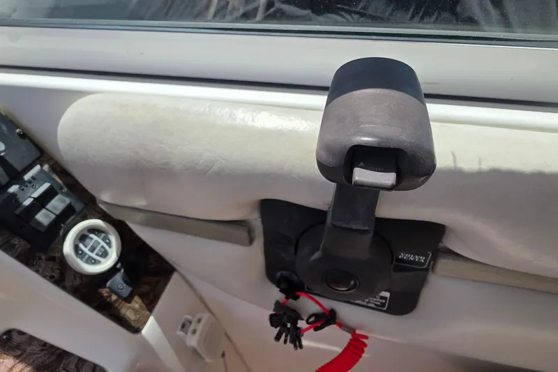 Throttle control and gauge on a 2001 Doral 250se boat dashboard.
