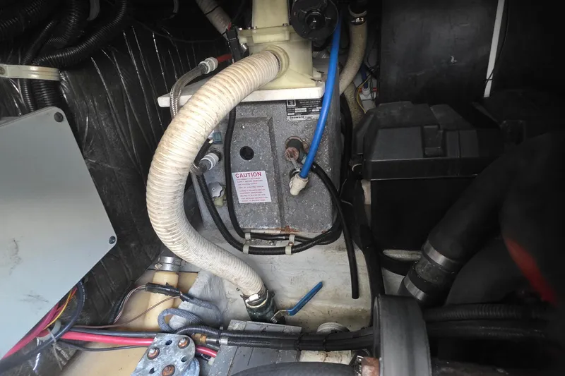 Engine compartment of a 2001 Doral 250se boat, showing hoses and components.