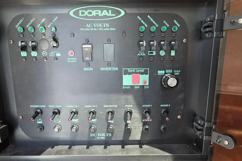 Control panel of a 2001 Doral 250se boat, featuring various switches and indicators.