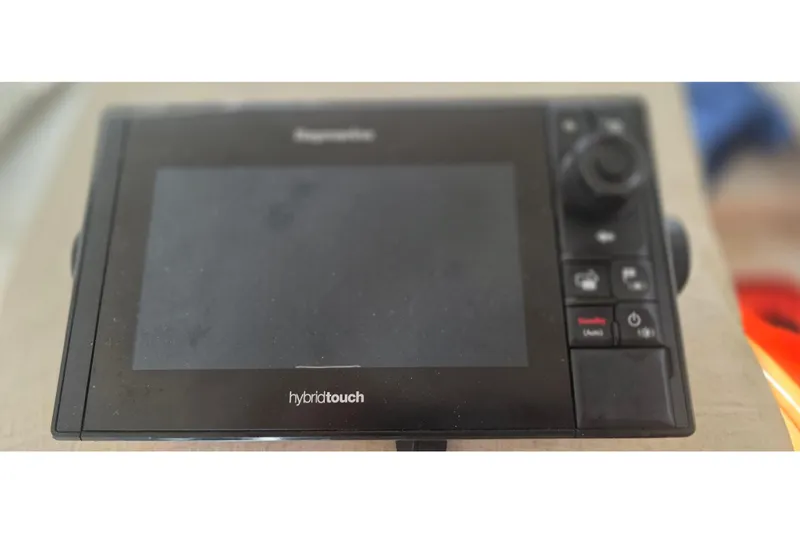 Raymarine HybridTouch marine display on a 2001 Doral 250se boat dashboard.