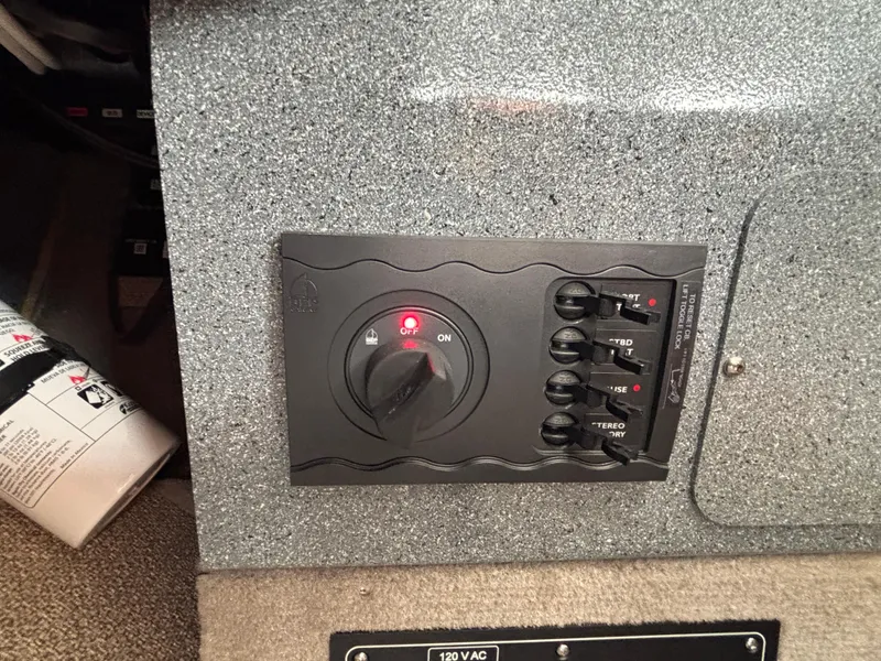 Control panel of 2023 KingFisher 3025 Destination boat with switches and indicator light.