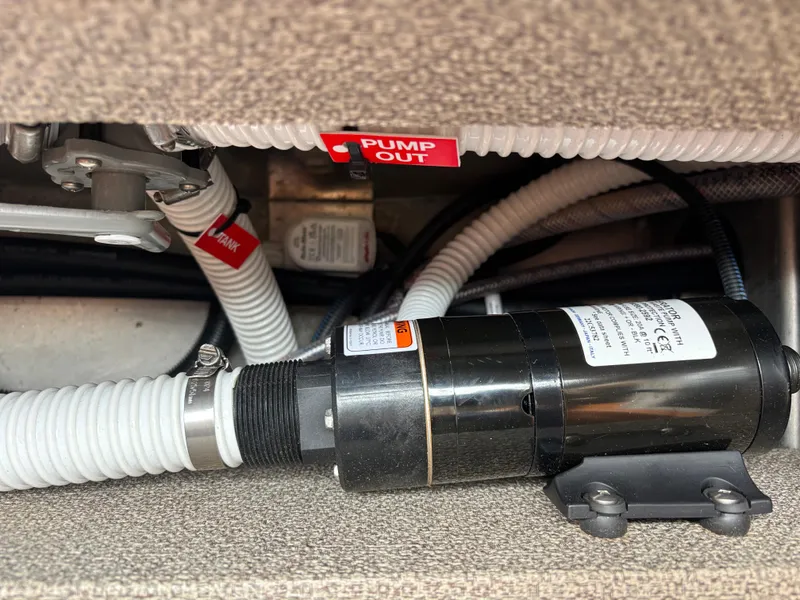 Boat plumbing system with pump and labeled hoses in a 2023 KingFisher 3025 Destination.