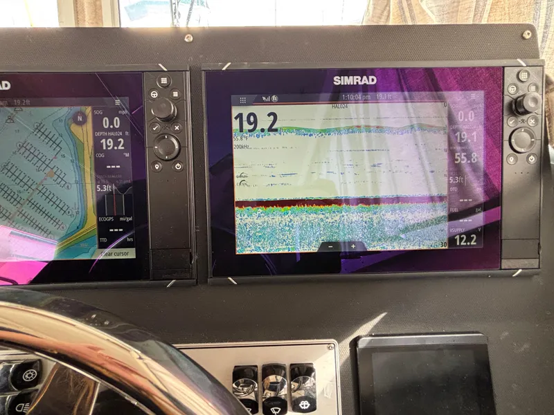 Dashboard of 2023 KingFisher 3025 Destination with Simrad navigation displays.