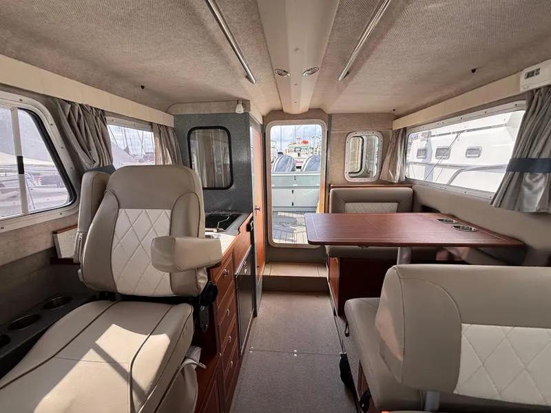 2023 KingFisher 3025 Destination interior with seating and dining area.