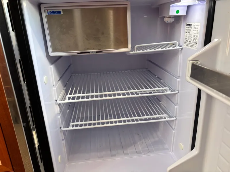 Empty refrigerator interior with wire shelves, KingFisher 3025 Destination model, 2023.