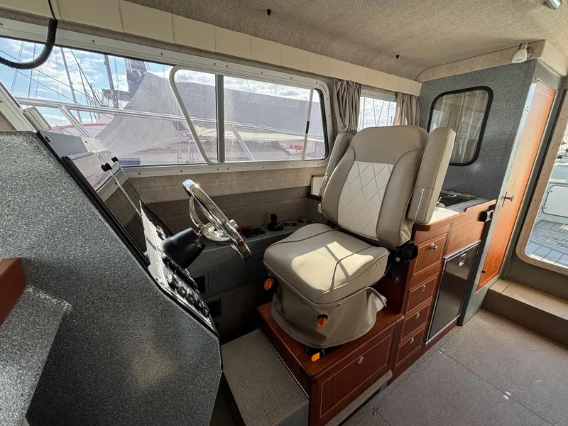 2023 KingFisher 3025 Destination boat interior with captain's chair and control panel.