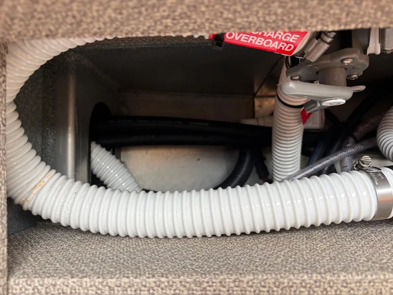 Interior view of 2023 KingFisher 3025 Destination boat showing hoses and wiring.