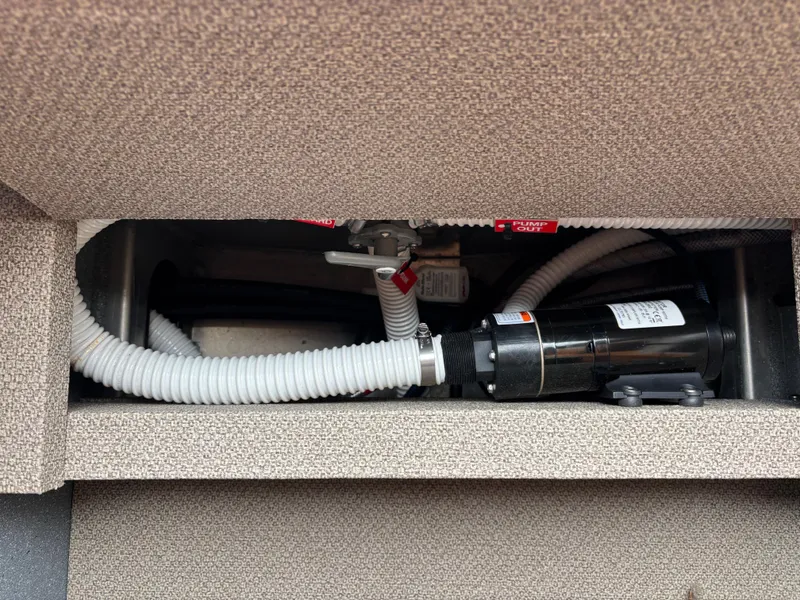 2023 KingFisher 3025 Destination boat plumbing system with hoses and pump.