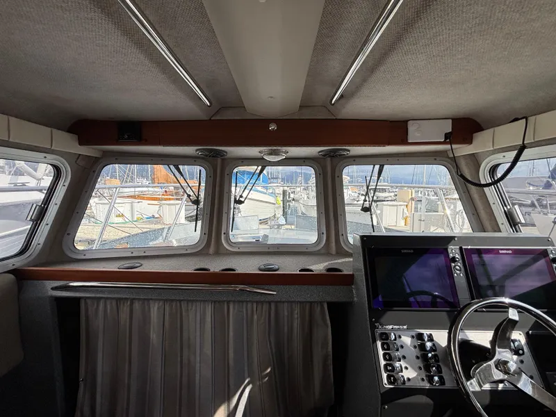 Interior view of 2023 KingFisher 3025 Destination boat cockpit with navigation controls.