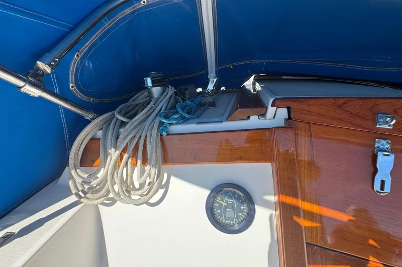Cockpit of 1985 Catalina 38 sailboat with ropes and wooden paneling.