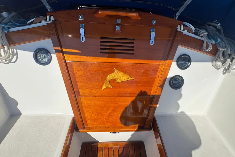 1985 Catalina 38 sailboat cockpit with polished wood paneling and nautical instruments.