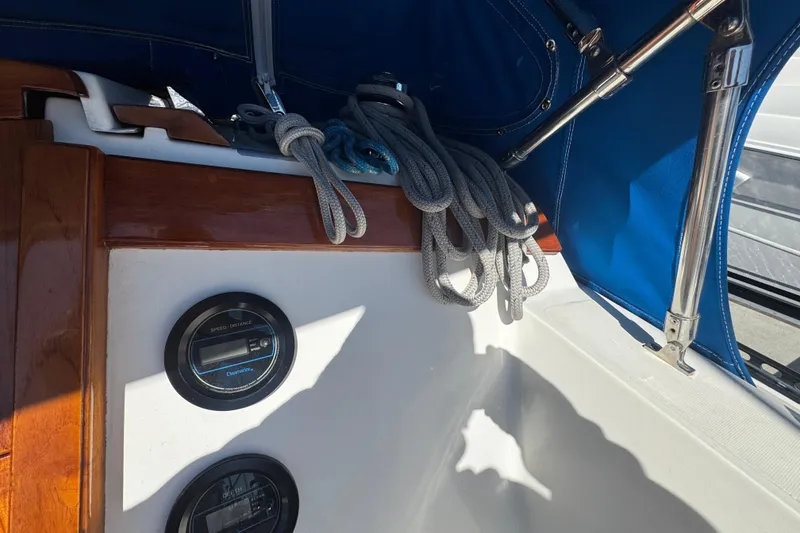 Cockpit of 1985 Catalina 38 sailboat with ropes and navigation instruments.