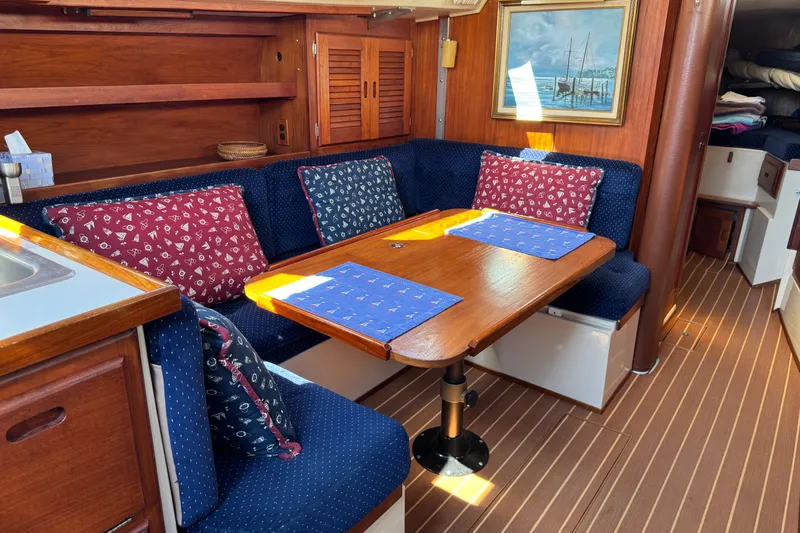 Interior of a 1985 Catalina 38 sailboat with cozy seating and nautical decor.