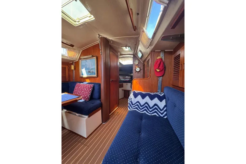 Interior of 1985 Catalina 38 sailboat with cozy seating and nautical decor.