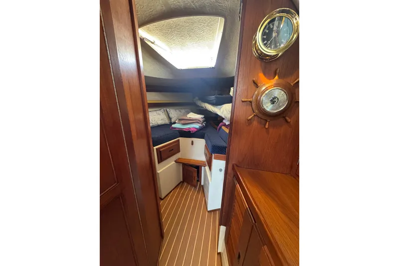 Cozy cabin interior of a 1985 Catalina 38 sailboat with wooden finishes and nautical decor.