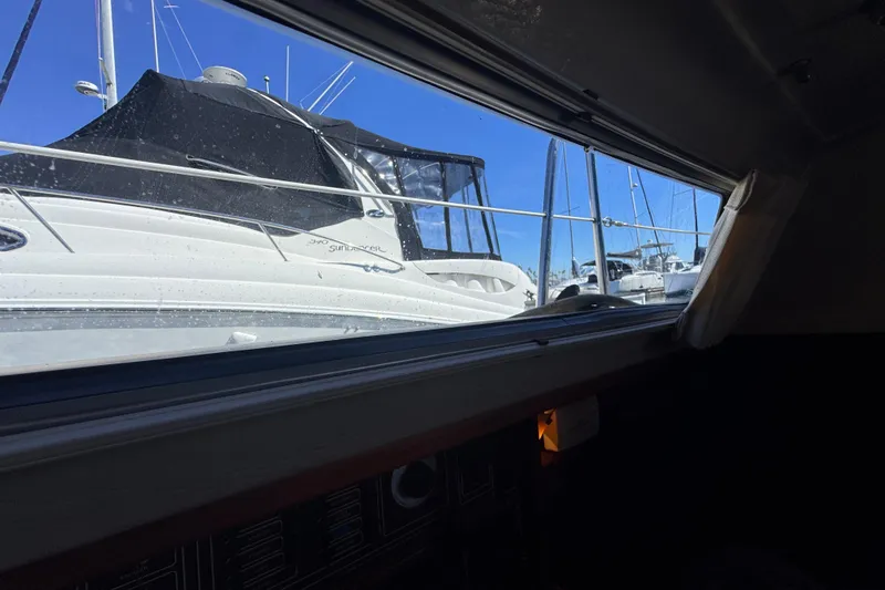 View from inside a 1985 Catalina 38 sailboat, overlooking a marina with yachts.