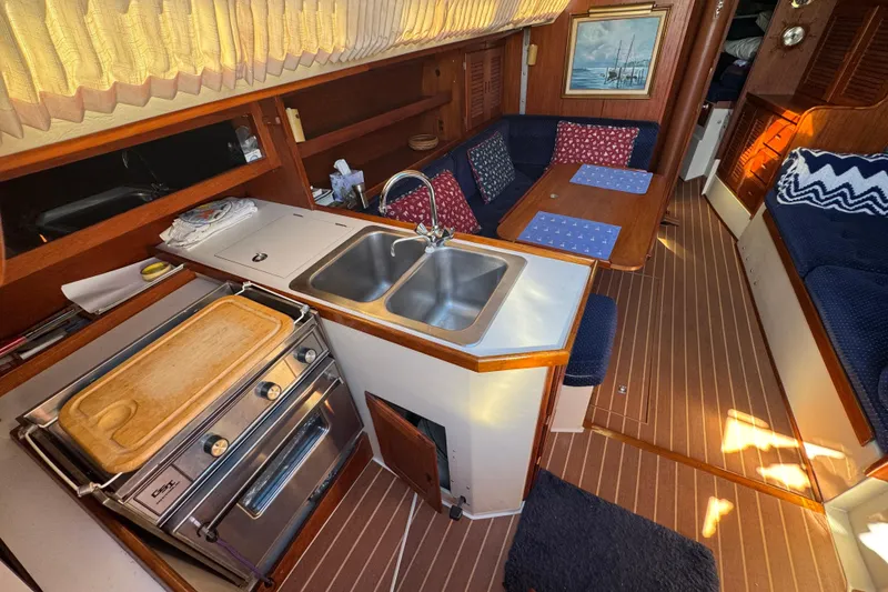 Interior of 1985 Catalina 38 sailboat with kitchen and seating area.