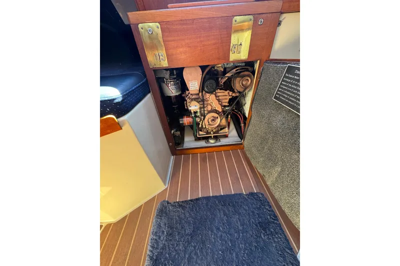 Engine compartment of a 1985 Catalina 38 sailboat, showcasing mechanical components.