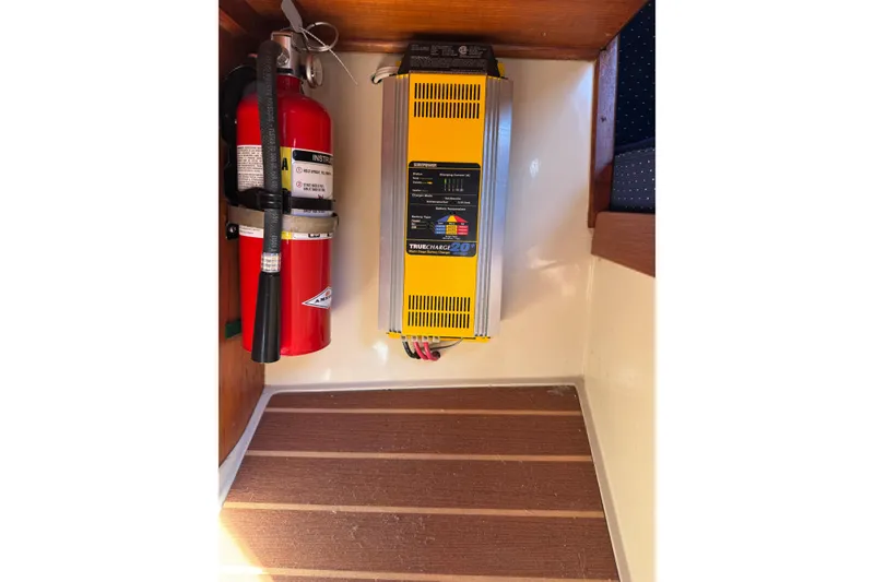 Fire extinguisher and battery charger in 1985 Catalina 38 boat interior.