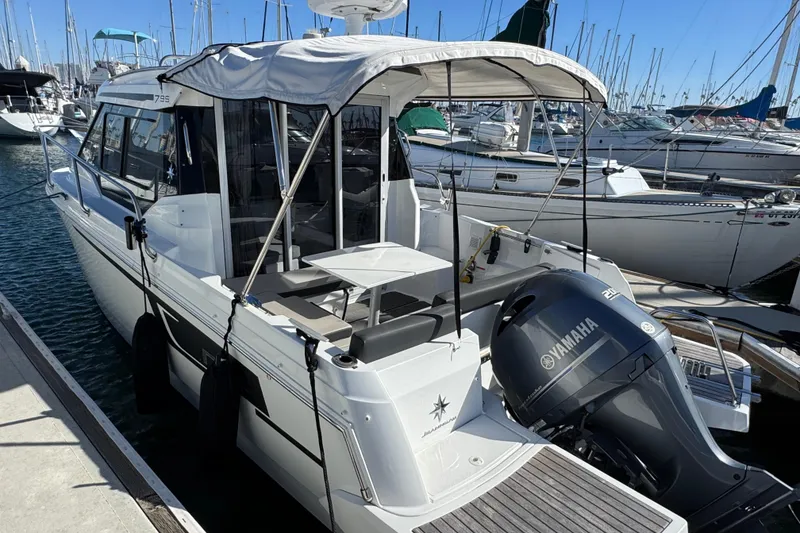 2020 Jeanneau NC 795 boat docked with Yamaha outboard motor, marina background.