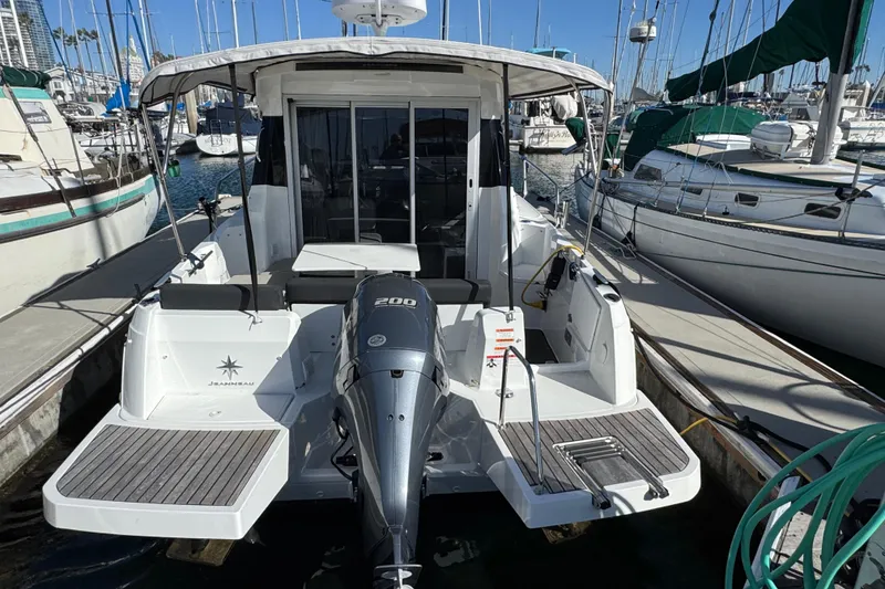 2020 Jeanneau NC 795 boat docked at marina, featuring a 200 HP outboard motor.