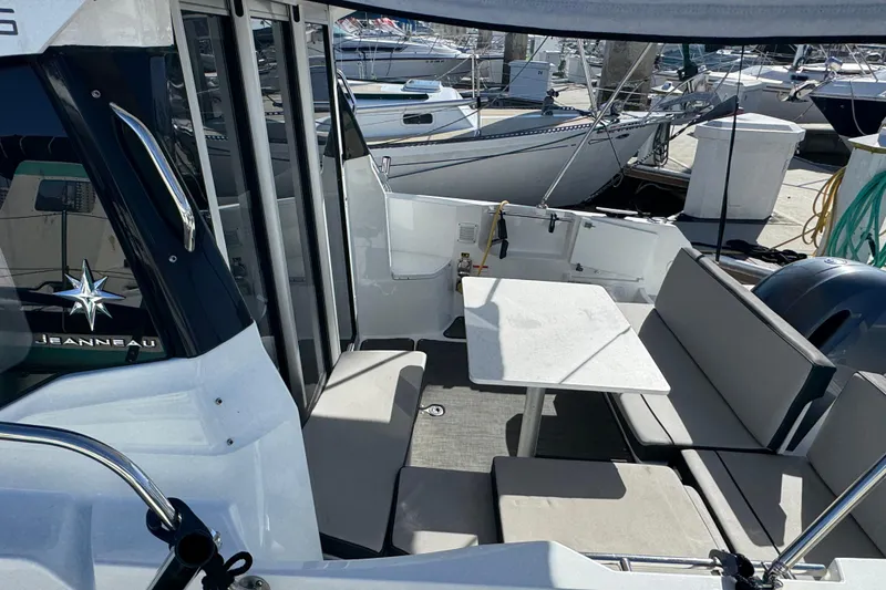 2020 Jeanneau NC 795 boat interior with seating and table, docked at marina.