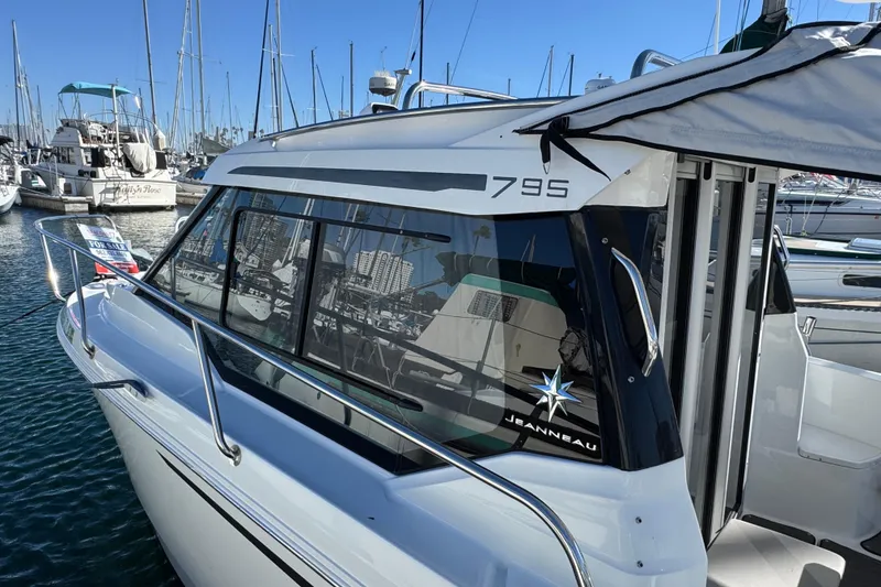 2020 Jeanneau NC 795 boat docked in marina, side view with reflections.