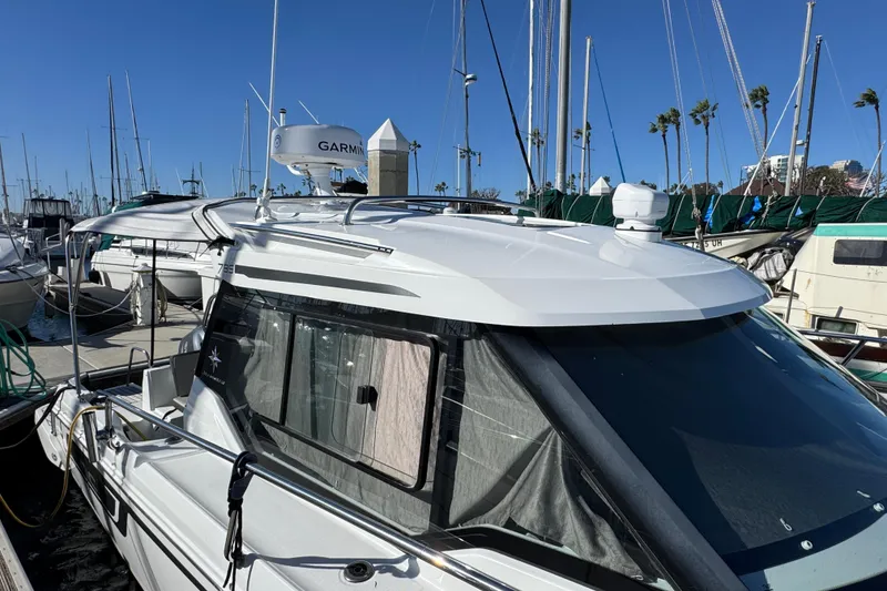 2020 Jeanneau NC 795 boat docked at marina with clear blue sky.