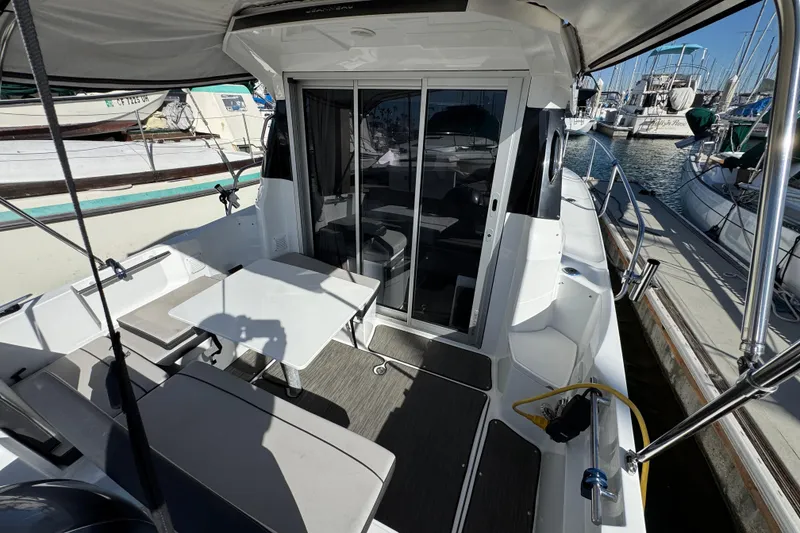 2020 Jeanneau NC 795 boat interior with seating and table, docked at marina.