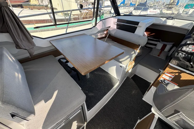 Interior of 2020 Jeanneau NC 795 boat with seating and table arrangement.