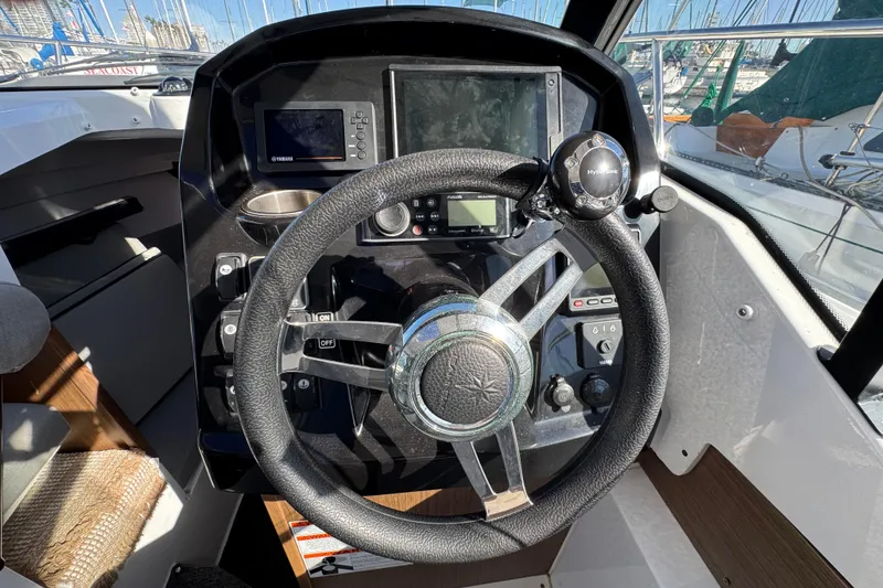 Steering console of a 2020 Jeanneau NC 795 boat with navigation equipment.