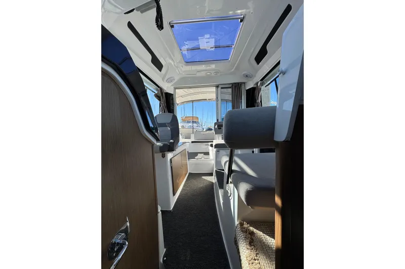 Interior view of 2020 Jeanneau NC 795 boat, featuring seating and skylight.