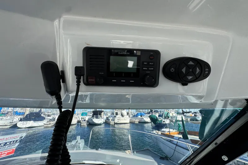 Control panel of a 2020 Jeanneau NC 795 boat with marina view.