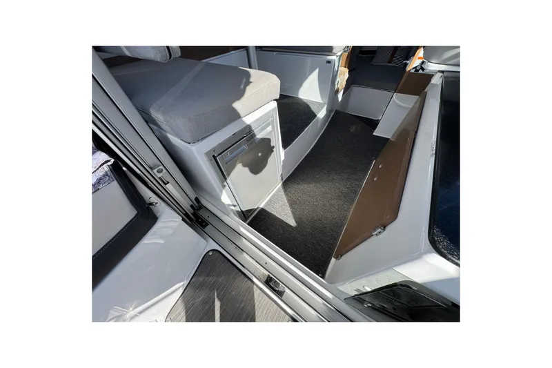 Interior view of 2020 Jeanneau NC 795 boat, featuring seating and storage areas.