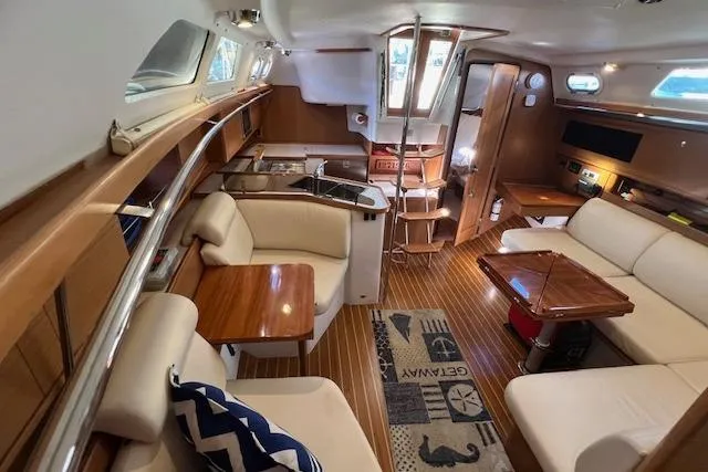 Interior of 2016 Catalina 385 sailboat with modern furnishings and wood accents.