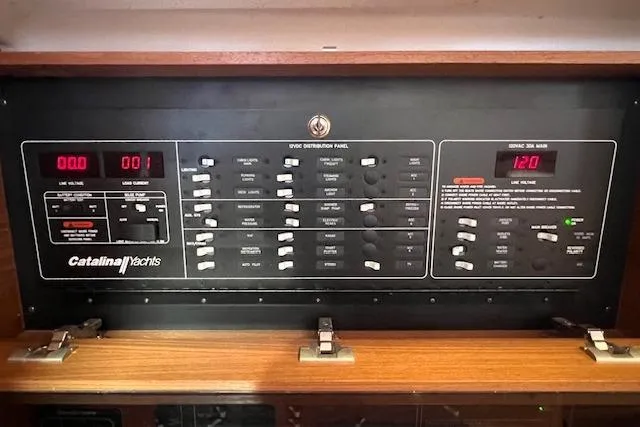 Electrical control panel of a 2016 Catalina 385 yacht, featuring various switches and displays.
