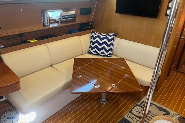 2016 Catalina 385 yacht interior with cozy seating and wooden table.
