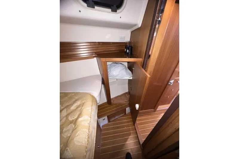 Interior of 2016 Catalina 385 sailboat with wooden cabinetry and cozy sleeping area.
