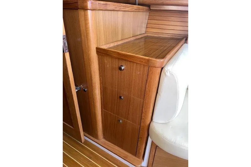 Wooden interior cabinetry in a 2016 Catalina 385 sailboat, featuring drawers and white seating.