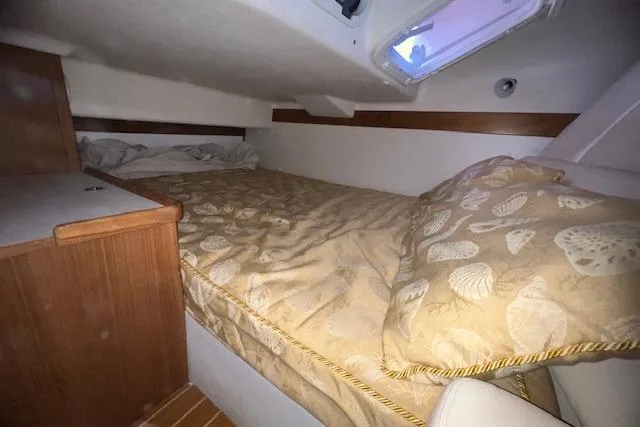 Cozy cabin interior of 2016 Catalina 385 sailboat with comfortable bedding.