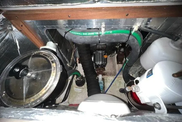 Engine compartment of a 2016 Catalina 385 sailboat, featuring hoses and mechanical components.