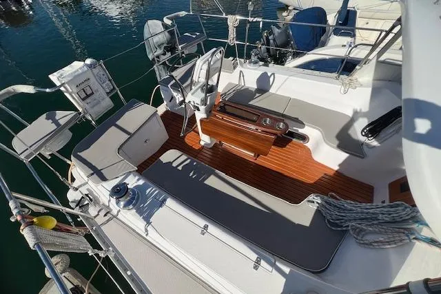 2016 Catalina 385 sailboat cockpit with seating, wooden flooring, and steering wheel.