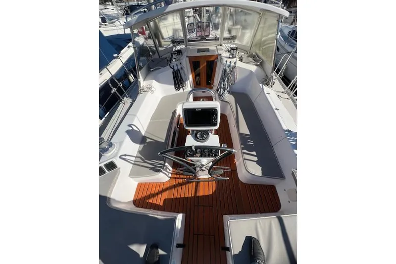 Cockpit of 2016 Catalina 385 sailboat with wooden flooring and navigation equipment.