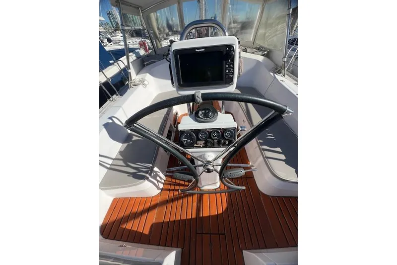 Cockpit of 2016 Catalina 385 sailboat with navigation equipment and wooden flooring.
