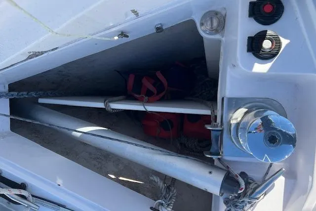 Storage compartment on a 2016 Catalina 385 sailboat with equipment and life jackets.