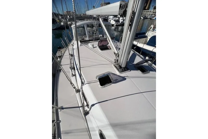 Sailboat deck of 2016 Catalina 385, featuring sleek design and marina backdrop.